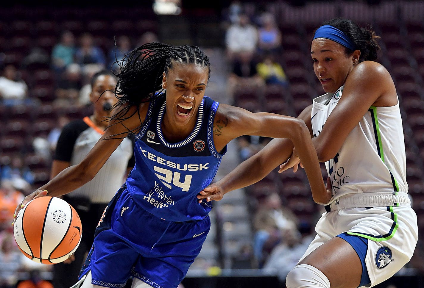 Connecticut's DeWanna Bonner attempts to move past the Lynx's Napheesa Collier