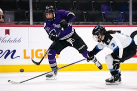 Minnesota forward Sophia Kunin, left, makes a pass during a PWHL playoff game against Toronto on May 15 in St. Paul.