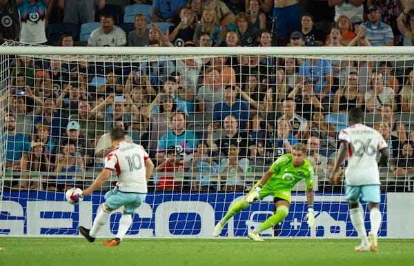 Minnesota United goalkeeper Dayne St. Clair (97) went to his right and Chicago Fire midfielder Xherdan Shaqiri (10) shot a penalty kick to the left to