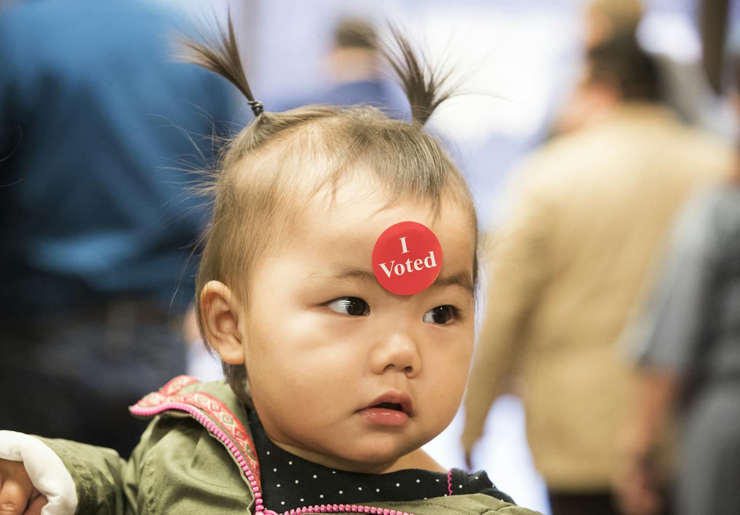 One-year-old Harper Her gets a sticker after attending early voting with her mother at the Ramsey County Elections office. ] (Leila Navidi/Star Tribune) leila.navidi@startribune.com BACKGROUND INFORMATION: Early voting at the Ramsey County Elections office in St. Paul on Friday, November 4, 2016.