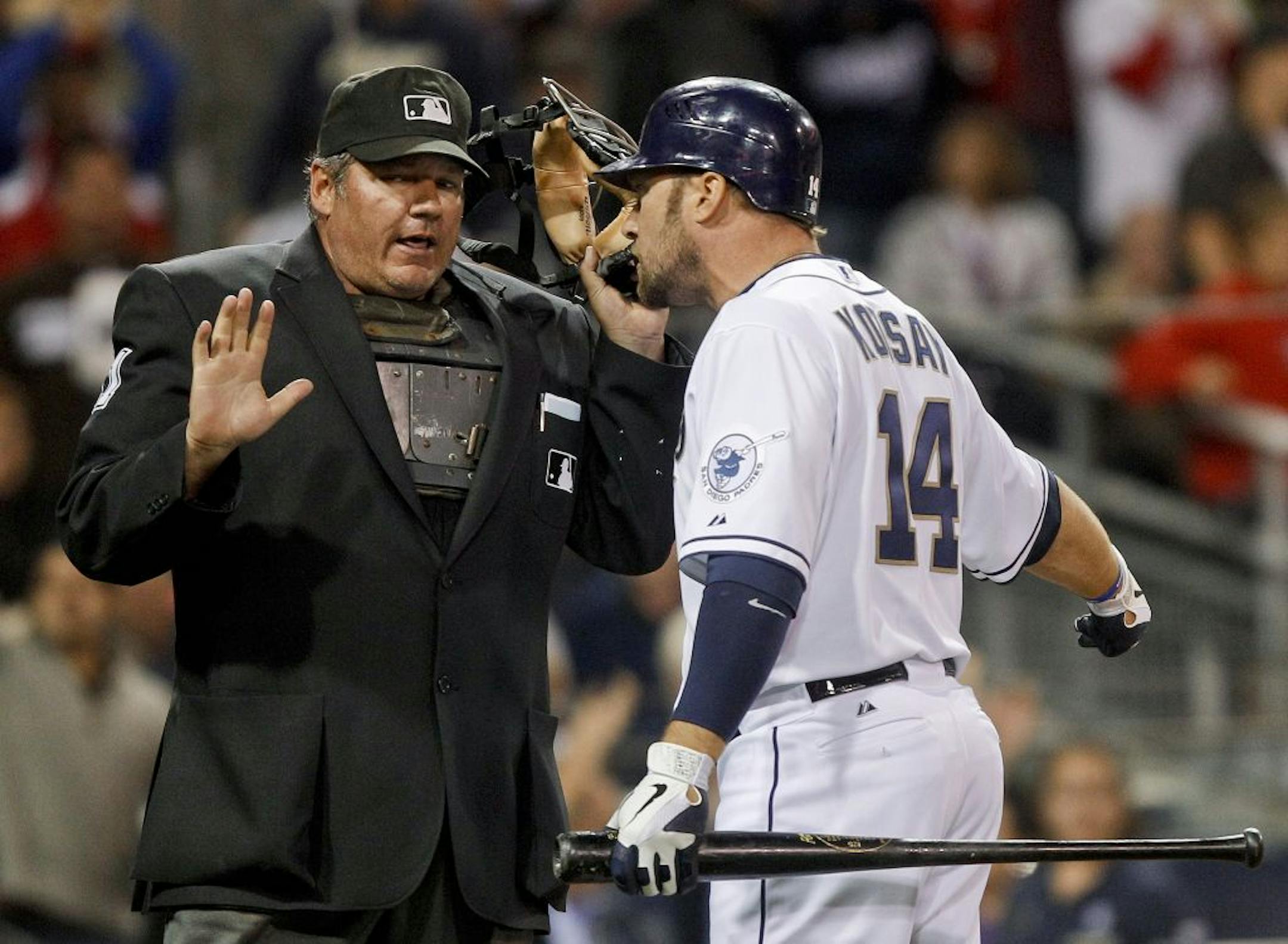 San Diego Padres' Mark Kotsay argues with home plate umpire Hunter Wendelstedt after being called out on strikes to end the seventh inning with two runners on base during a baseball game against the Philadelphia Phillies, Thursday, April 19, 2012, in San Diego.