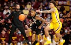 Purdue Fort Wayne guard Jalon Pipkins (50) drives against Minnesota guard Sean Sutherlin (24) and forward Charlie Daniels (15) in the first half of an