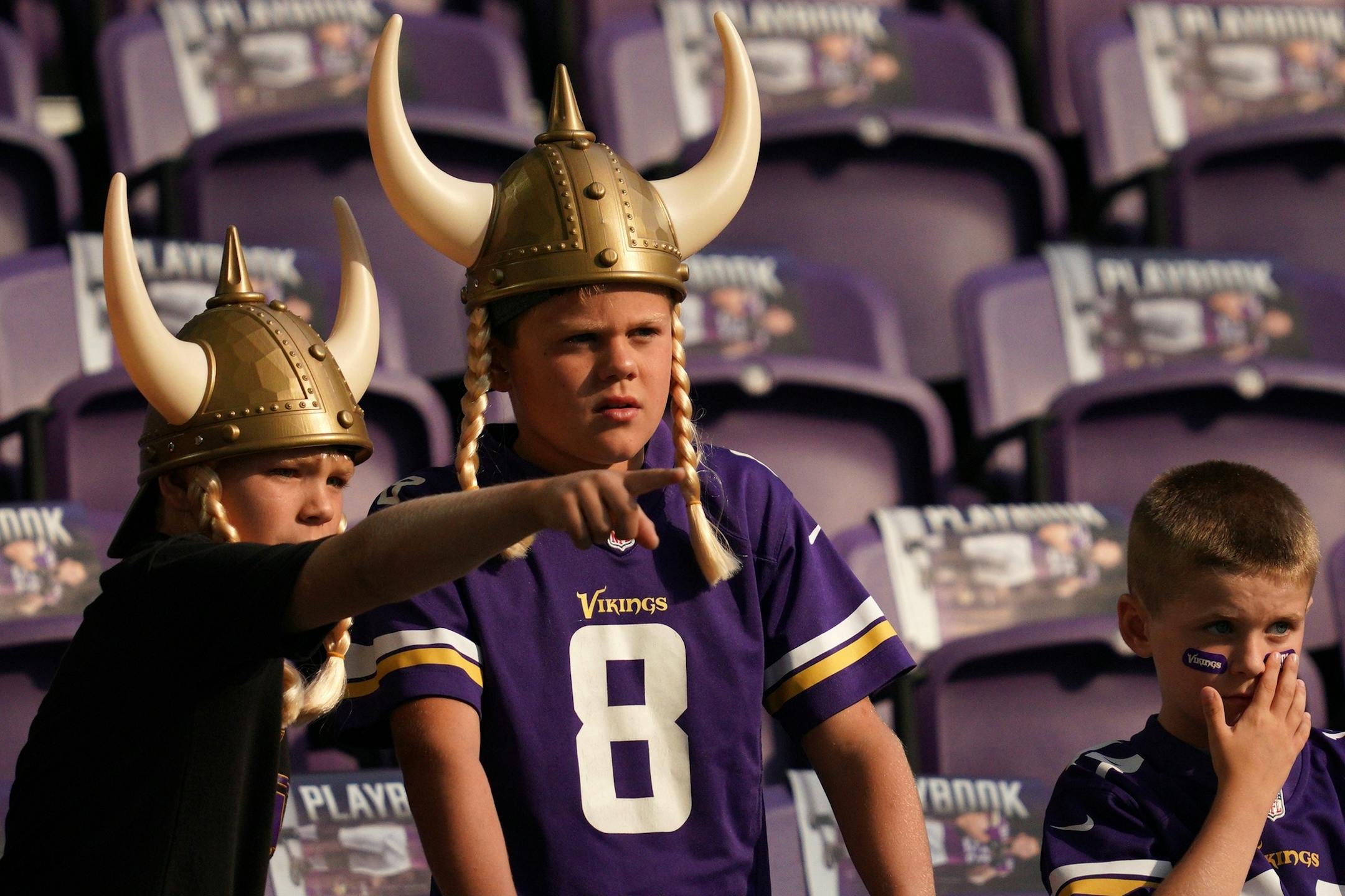 A trio of young fans watched as the Minnesota Vikings warmed up on the field prior to Sunday's game against the Seattle Seahawks.