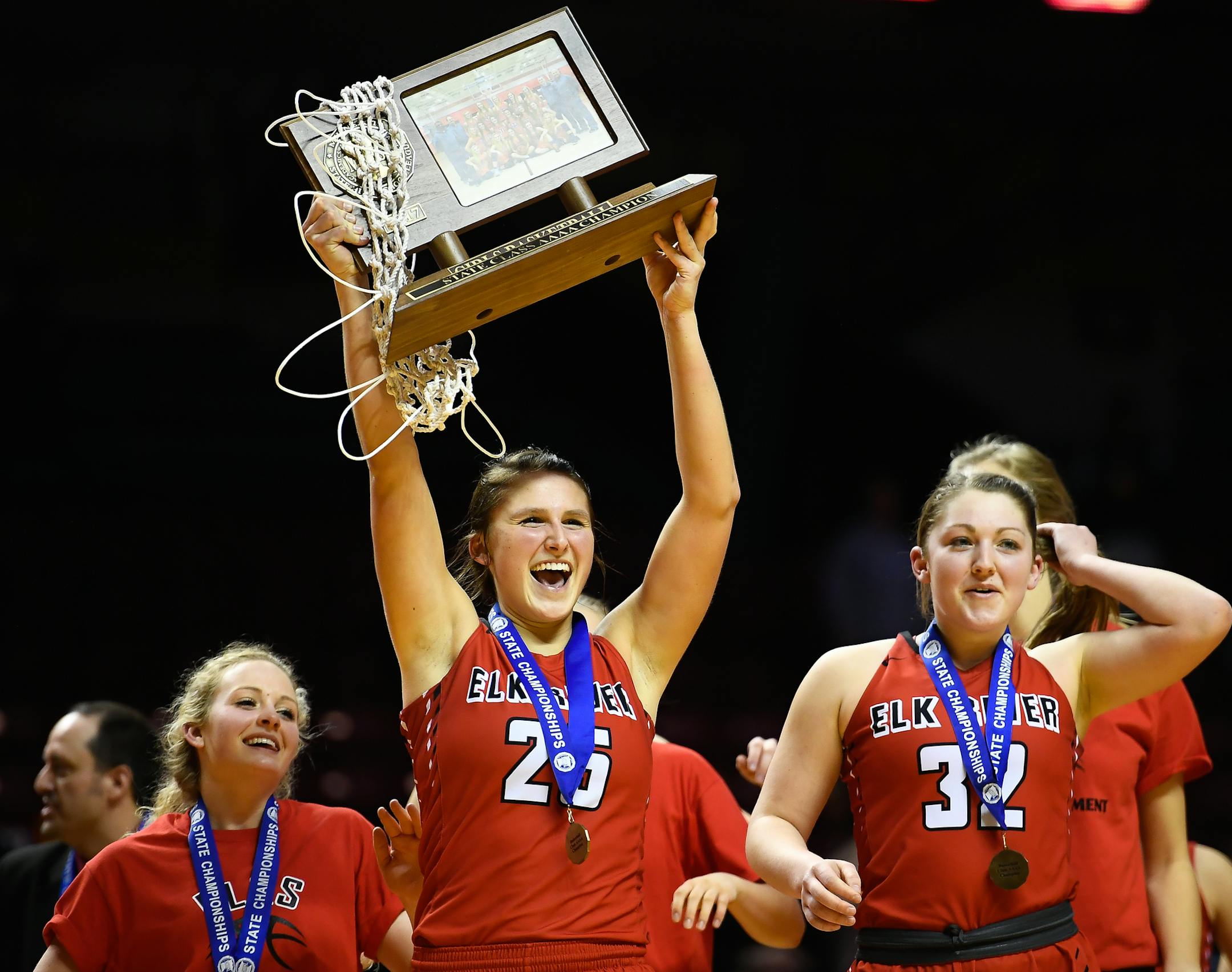 Elk River forward Sidney Wentland (25) hoisted the 4A championship trophy above her head as she marched toward the student section with teammates, including guard Gabi Haack (32). ] AARON LAVINSKY &#xef; aaron.lavinsky@startribune.com Elk River played Hopkins in the Class 4A girls' basketball championship game on Saturday, March 18, 2017 at Williams Arena in Minneapolis, Minn.