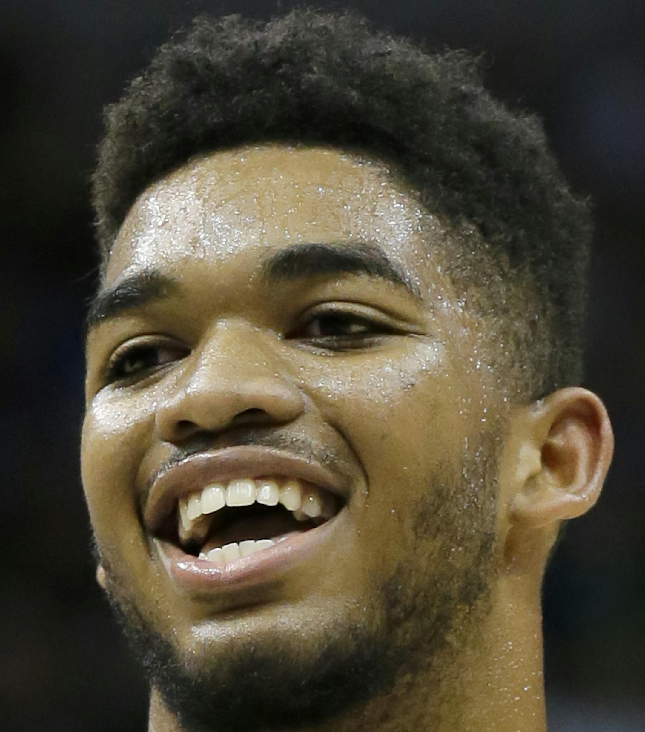 Minnesota Timberwolves center Karl-Anthony Towns laughs at a teammate during an NBA basketball scrimmage in Minneapolis, Wednesday, July 8, 2015. (AP Photo/Ann Heisenfelt)