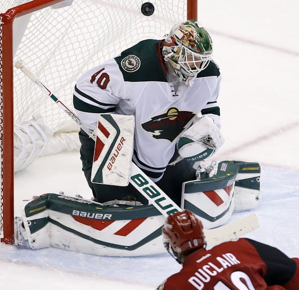Arizona Coyotes' Anthony Duclair (10) scores a goal against Minnesota Wild's Devan Dubnyk (40) during the second period of an NHL hockey game Thursday