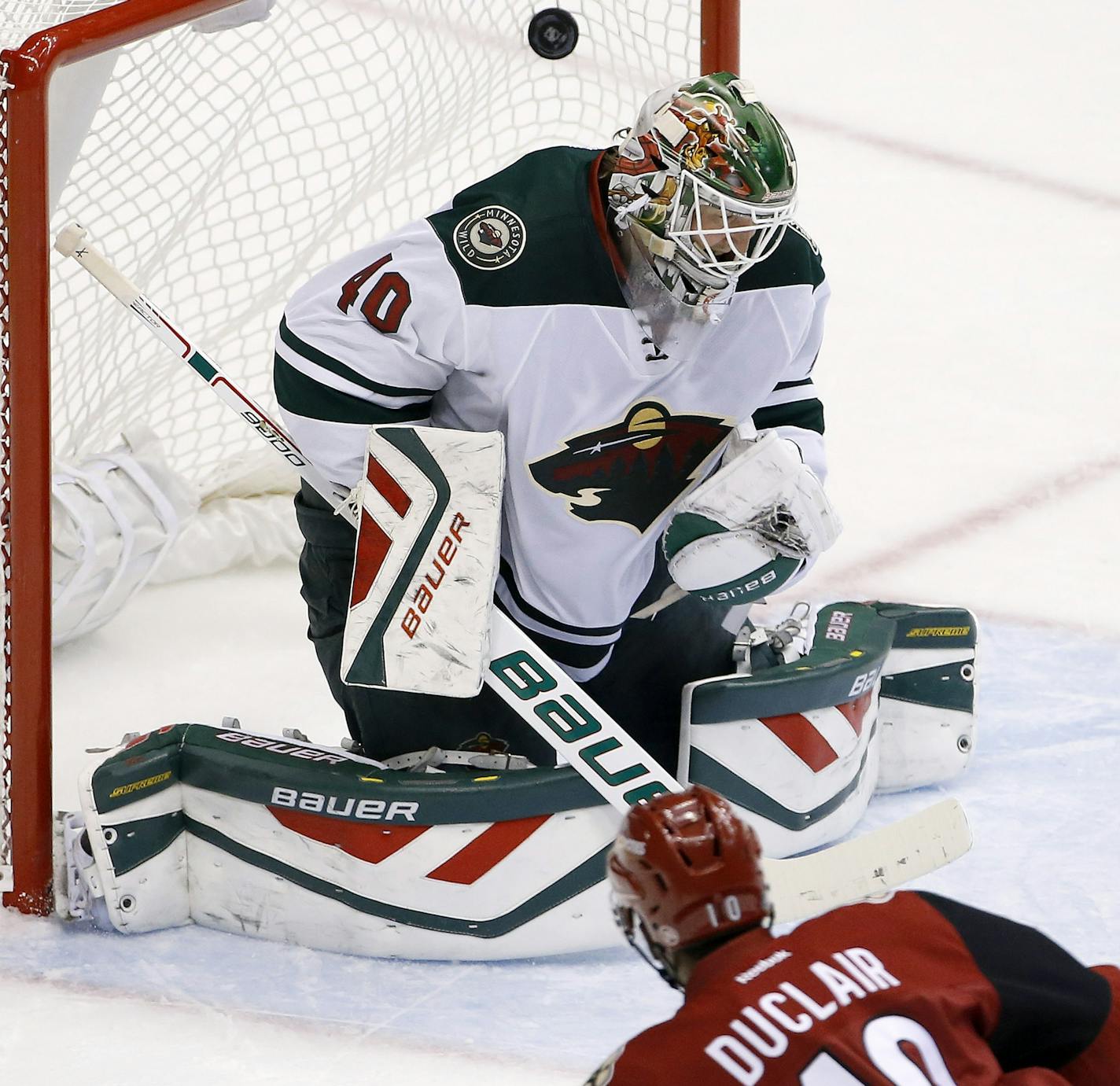 Arizona Coyotes' Anthony Duclair (10) scores a goal against Minnesota Wild's Devan Dubnyk (40) during the second period of an NHL hockey game Thursday, Oct. 15, 2015, in Glendale, Ariz. (AP Photo/Ross D. Franklin)