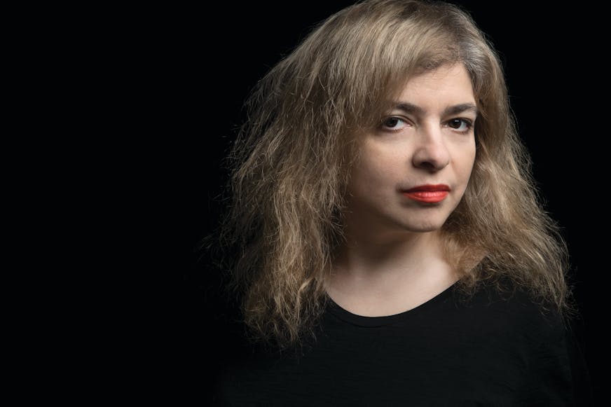 photo of author Mariana Enriquez, against a black backdrop