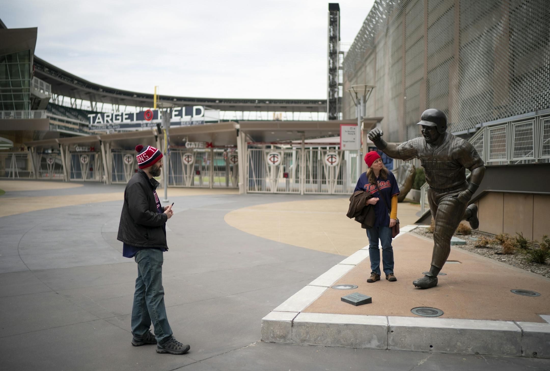 Michele Schluender posed next to the state of Kirby Puckett before being photographed by her husband, Joe, on the plaza outside Target Field at a time when it should have been busy with fans arriving for the home opener. "We come to opening day every year," Joe said. "This would have been out tenth year."