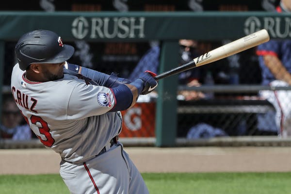 Minnesota Twins' Nelson Cruz hits a three-run home run against the Chicago White Sox during the eighth inning of a baseball game in Chicago, Sunday, J