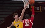 Gophers center Liam Robbins defended the rim against Buckeyes forward E.J. Liddell in the second half Sunday.