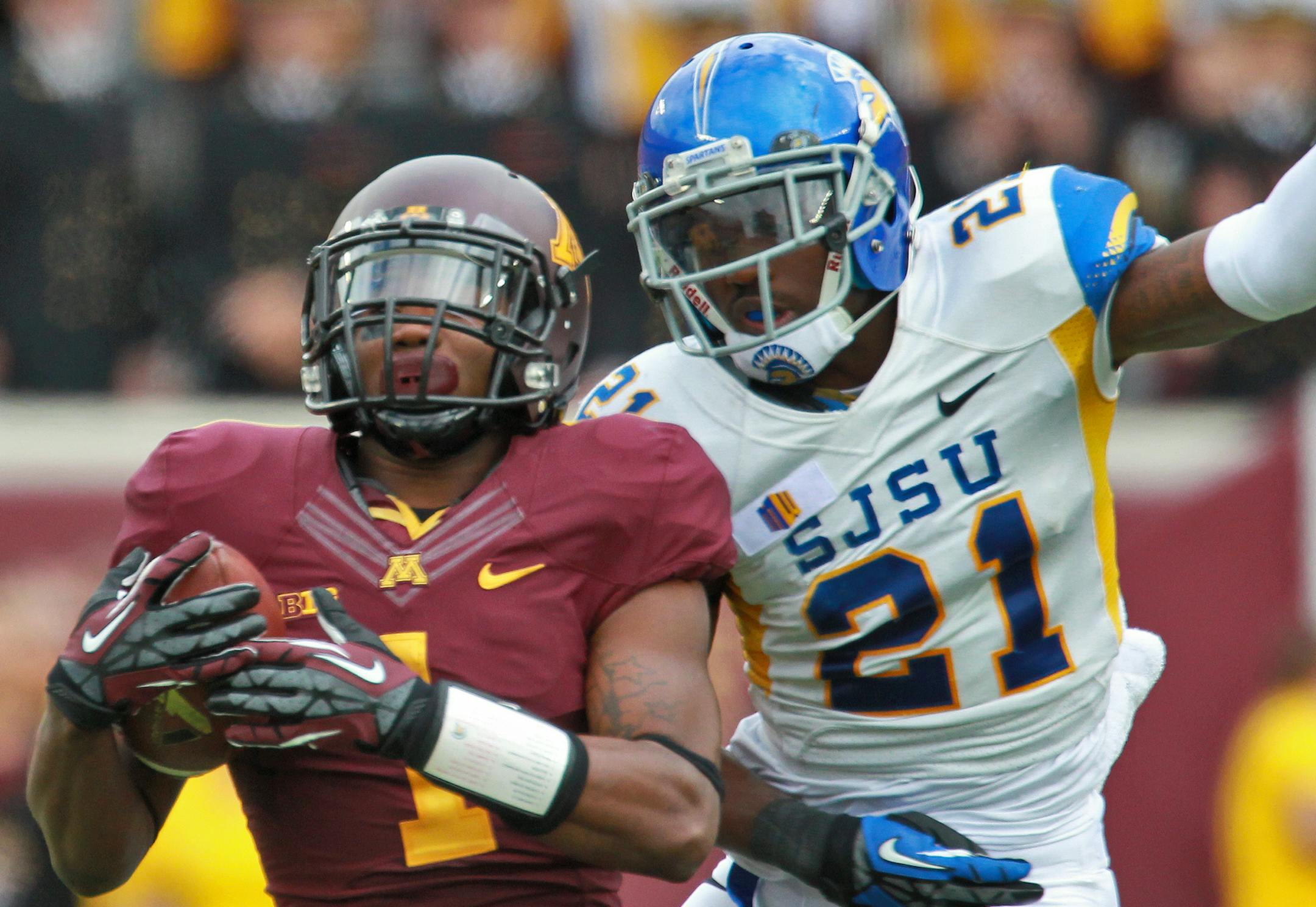 Minnesota Gophers vs.San Jose State football. Minnesota won 43-24. Minnesota quarterback Mitch Leidner had four rushing touchdown in the game with 151 yards gained running. Gophers receiver K J Maye hauled in a 40-yard pass beating San Jose State's Bene Benwikere (21) in 2nd half action. (MARLIN LEVISON/STARTRIBUNE(mlevison@startribune.com)