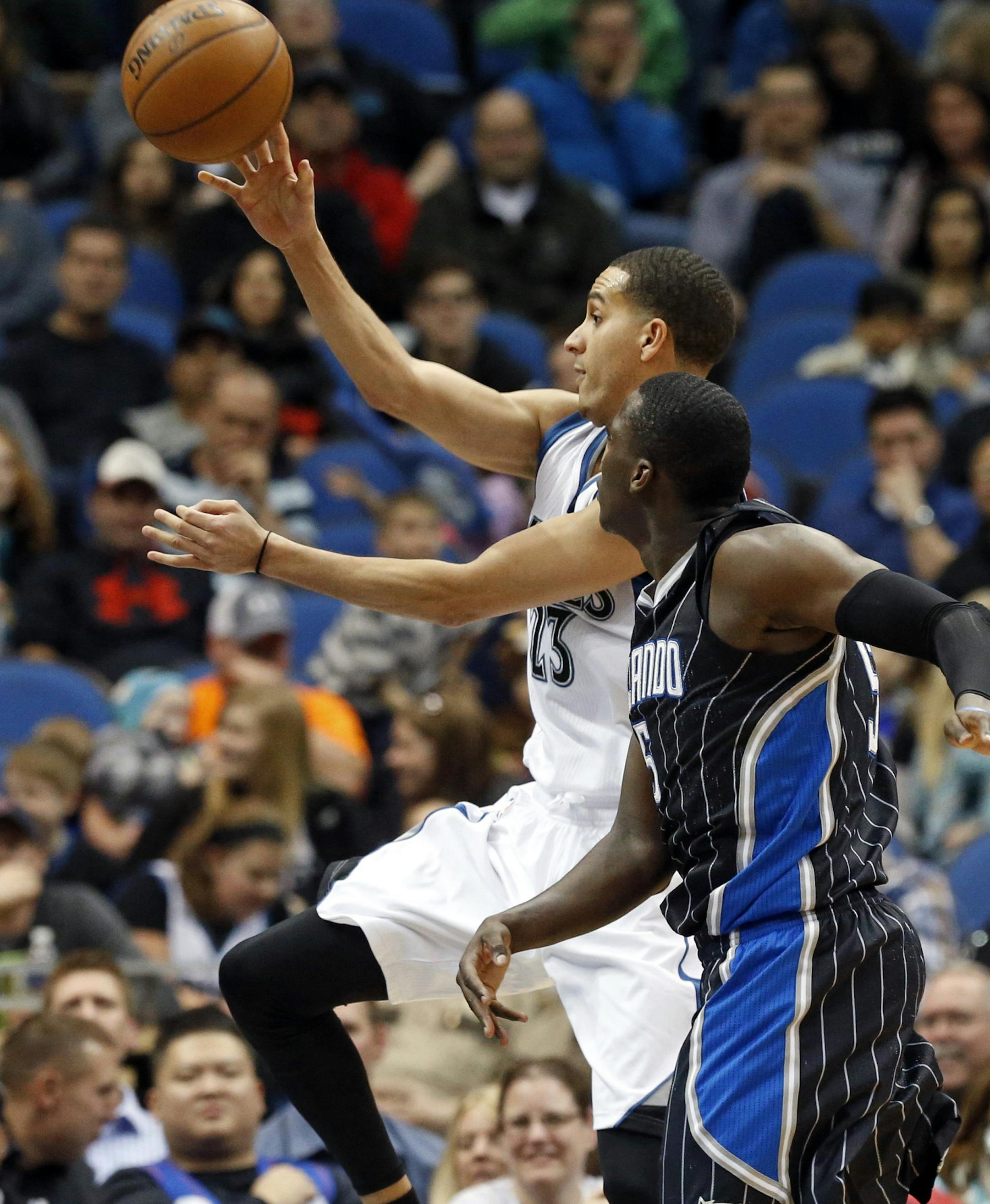 Minnesota Timberwolves’ Kevin Martin, left, passes against Orlando Magic’s Victor Oladipo in the second half of an NBA basketball game, Friday, April 3, 2015, in Minneapolis. The Magic won 97-84. (AP Photo/Jim Mone)