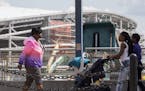 Pedestrians moved along a light rail platform in the Midway district as construction progresses on Minnesota United's Allianz Field.