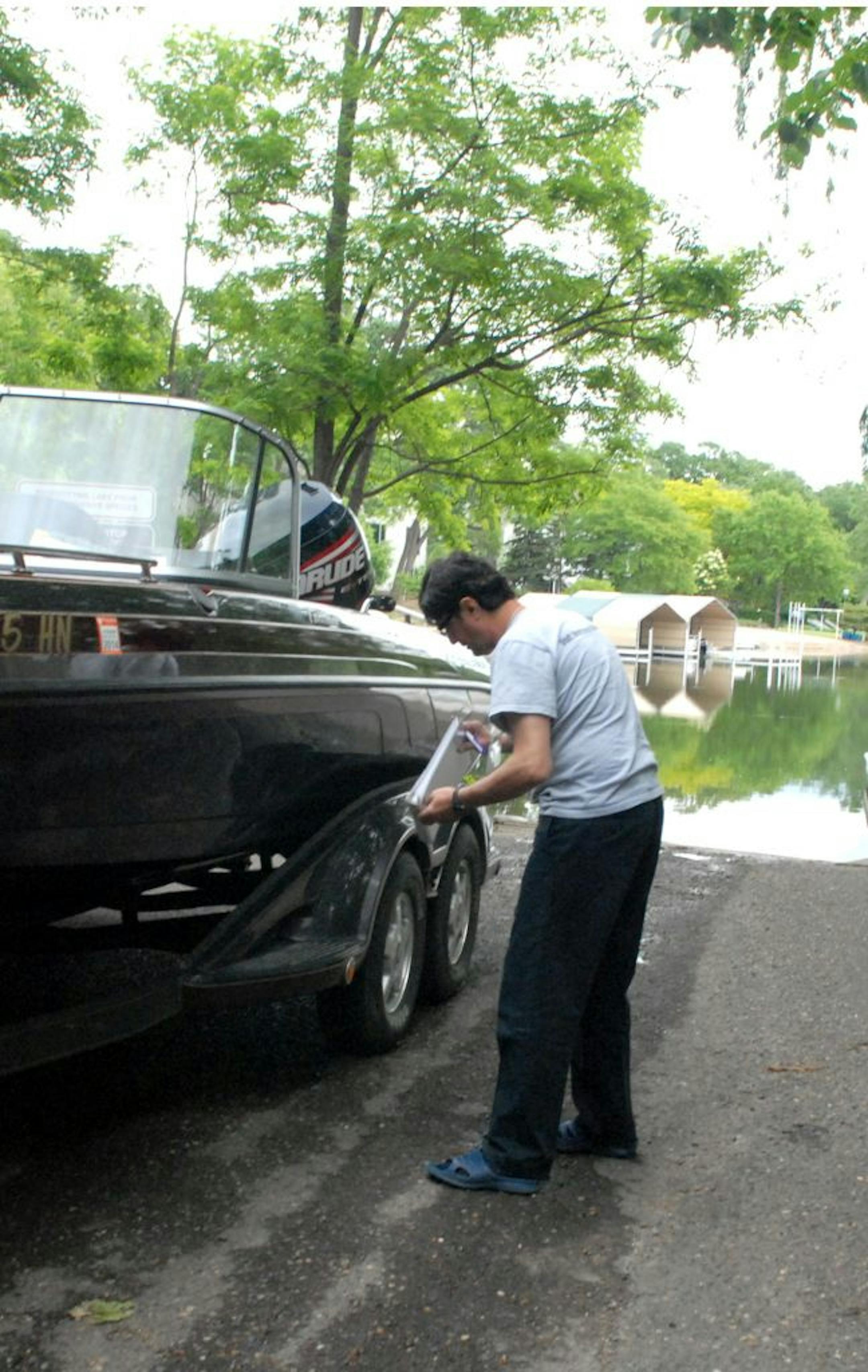 Kian Imani works for a private security firm contracted to staff the public landing on Christmas Lake with watercraft inspectors.