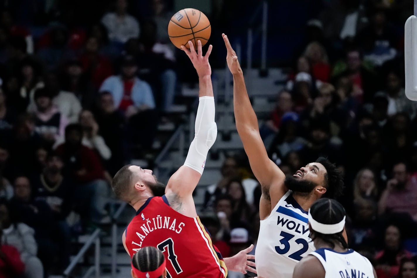 New Orleans Pelicans center Jonas Valanciunas (17) shoots against Minnesota Timberwolves center Karl-Anthony Towns (32) in the second half of an NBA basketball game in New Orleans, Monday, Dec. 11, 2023. The Pelicans won 121-107. (AP Photo/Gerald Herbert)