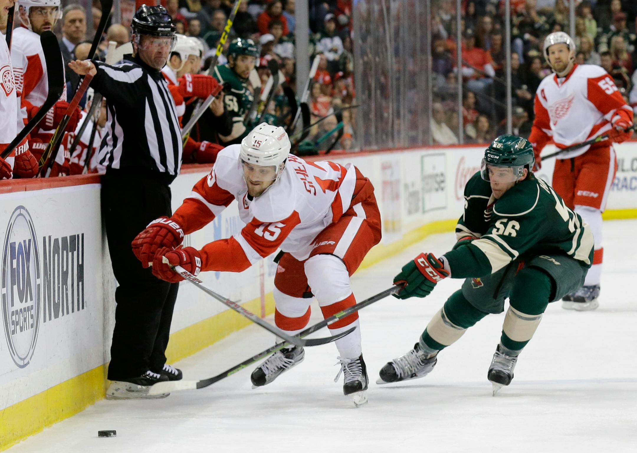 Detroit's Riley Sheahan, left, and the Wild's Erik Haula chased the puck during the Red Wings' 3-2 shootout victory on Saturday.