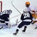 Gophers center Scott Reedy (19) took a shot and scored on Penn State goaltender Liam Souliere (31) in the first period.