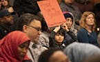 Andree Athorn, 5, a student from Windom Dual Immersion School, held a sign during the Minneapolis school board meeting Tuesday night.