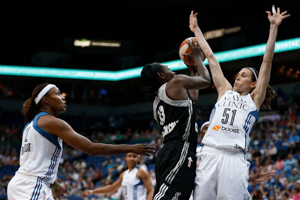 San Antonio Stars forward Sophia Young-Malcolm (33) tries to shoot against the defense of Minnesota Lynx guard Anna Cruz (51) during the first half of