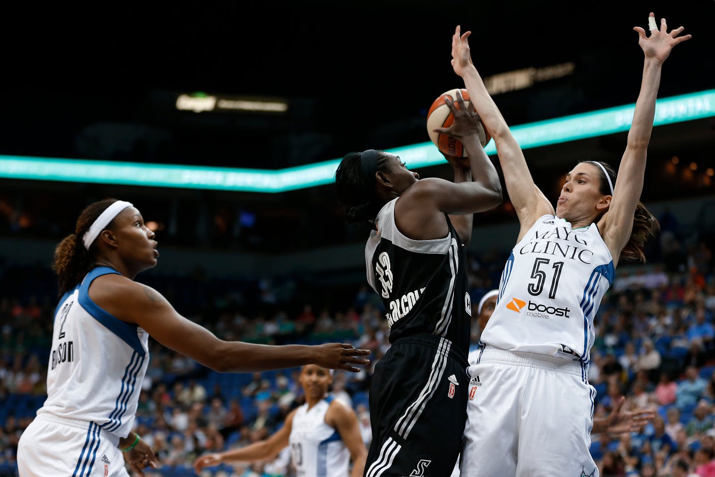 San Antonio Stars forward Sophia Young-Malcolm (33) tries to shoot against the defense of Minnesota Lynx guard Anna Cruz (51) during the first half of a WNBA basketball game, Tuesday, Aug. 11, 2015, in Minneapolis. (AP Photo/Stacy Bengs)