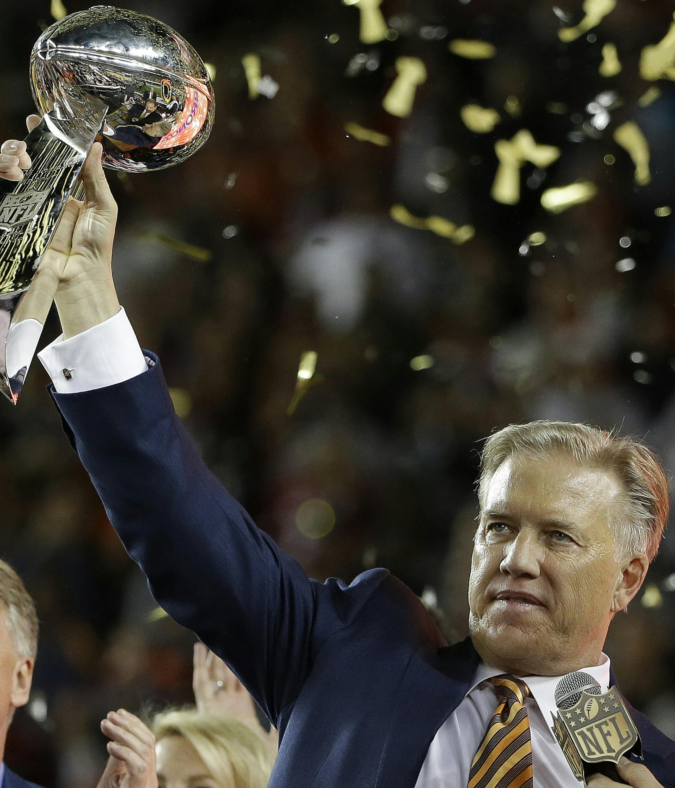 John Elway, General Manager and Executive Vice President of Football Operations for the Denver Broncos holds the championship trophy after the NFL Super Bowl 50 football game Carolina Panthers Sunday, Feb. 7, 2016, in Santa Clara, Calif. The Broncos won 24-10. (AP Photo/Marcio Jose Sanchez) ORG XMIT: NFL