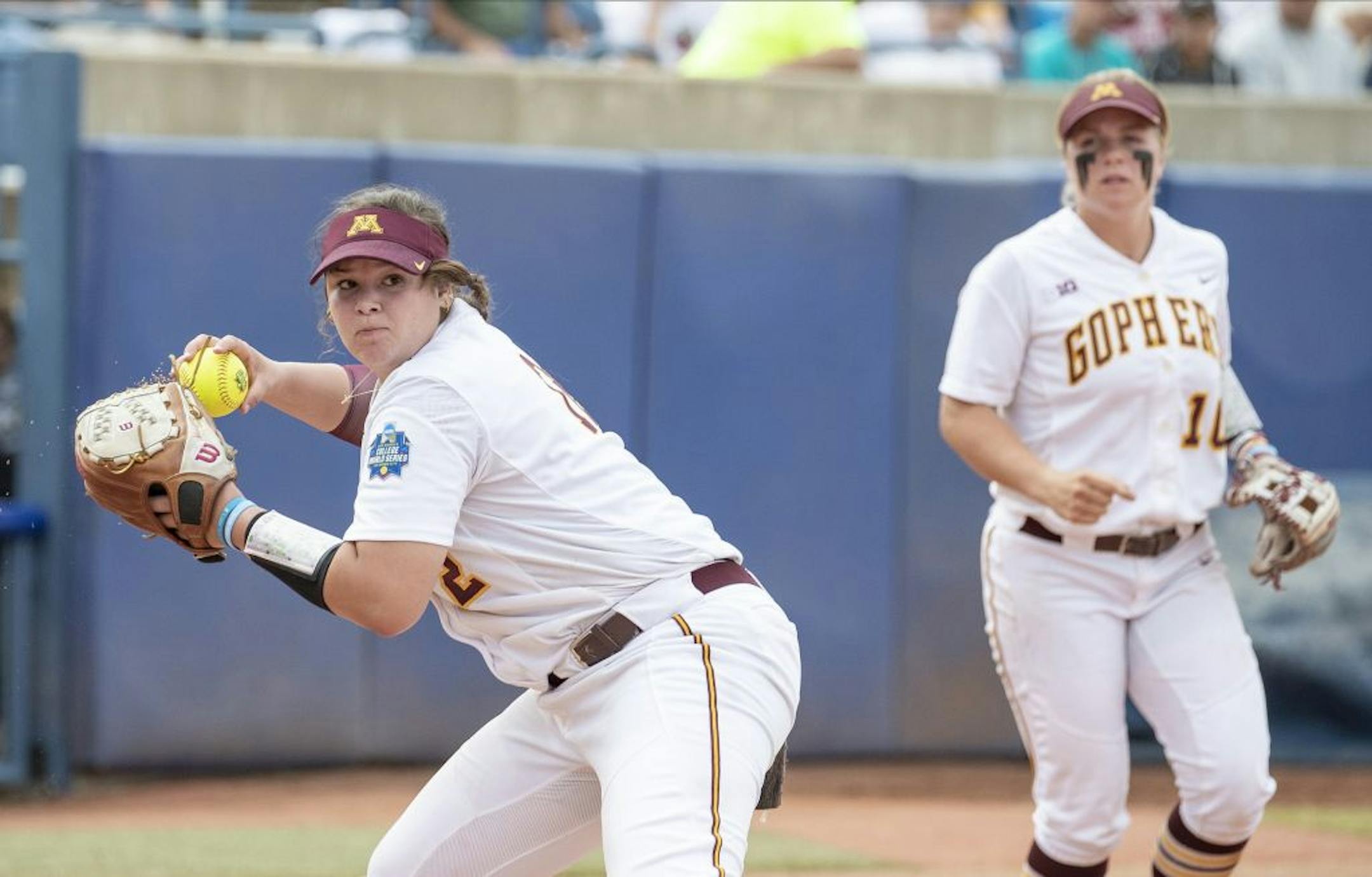 Minnesota pitcher Sydney Smith throws to first base for the Washington out during the seventh inning of the Women's College World Series at ASA Hall of Fame Stadium in Oklahoma City on Saturday, June 1, 2019. Washington won 5-3. Photo by: Alonzo J. Adams