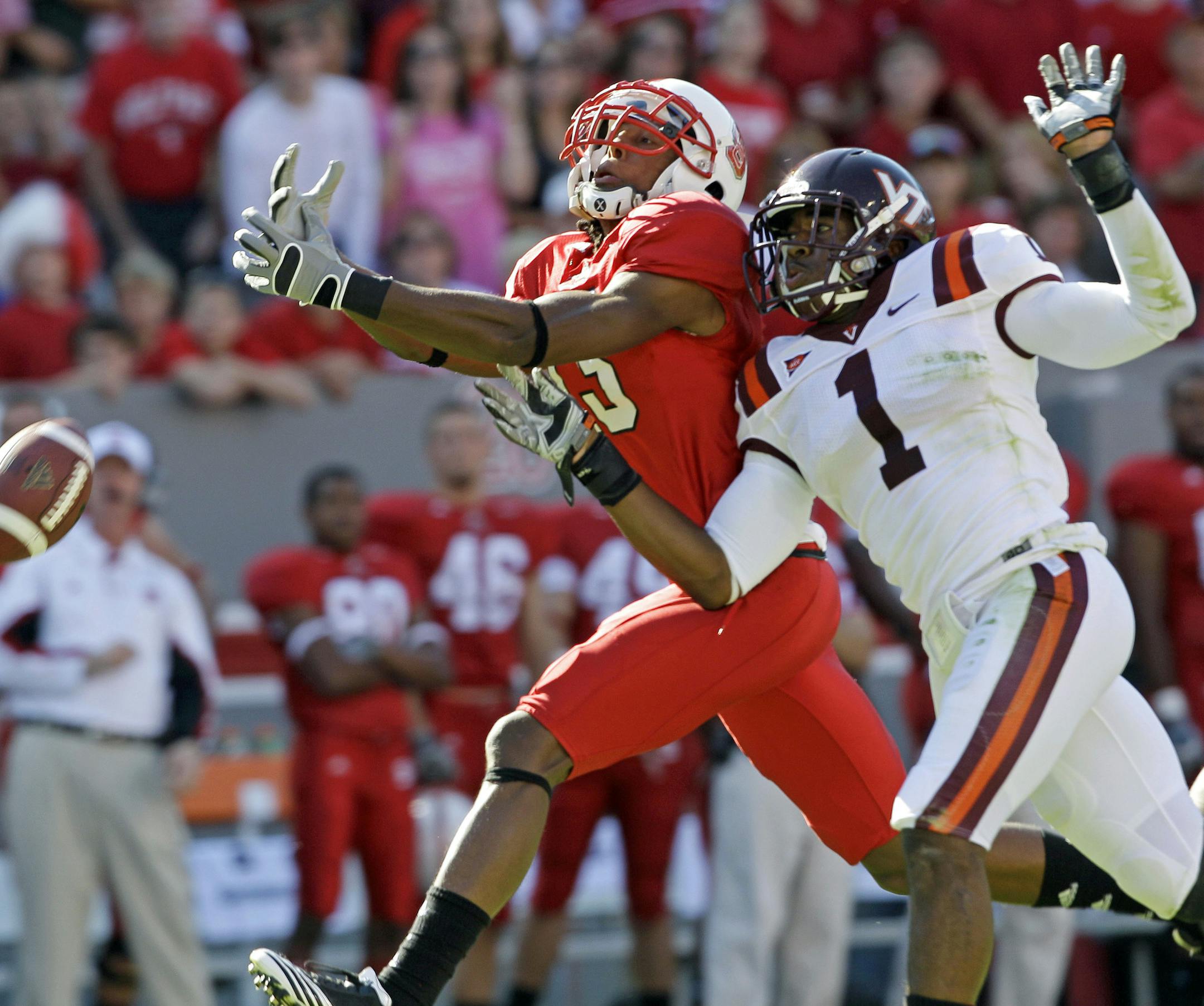 North Carolina State wide receiver Owen Spencer misses a pass as Virginia Tech safety Antone Exum (1) defends during the first half of an NCAA college football game in Raleigh, N.C., Saturday, Oct. 2, 2010. (AP Photo/Gerry Broome) ORG XMIT: NCGB108