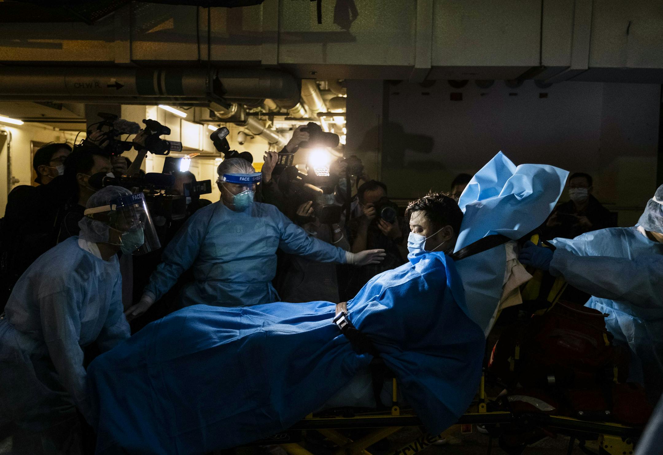 Paramedics transport a man believed to be Hong Kong’s first Wuhan coronavirus patient to a hospital on Wednesday, Jan. 22, 2019. The authorities are scrambling to control a virus that has sickened more than 470 people, killed nine, and spread around the region and to the United States. (Lam Yik Fei/The New York Times)