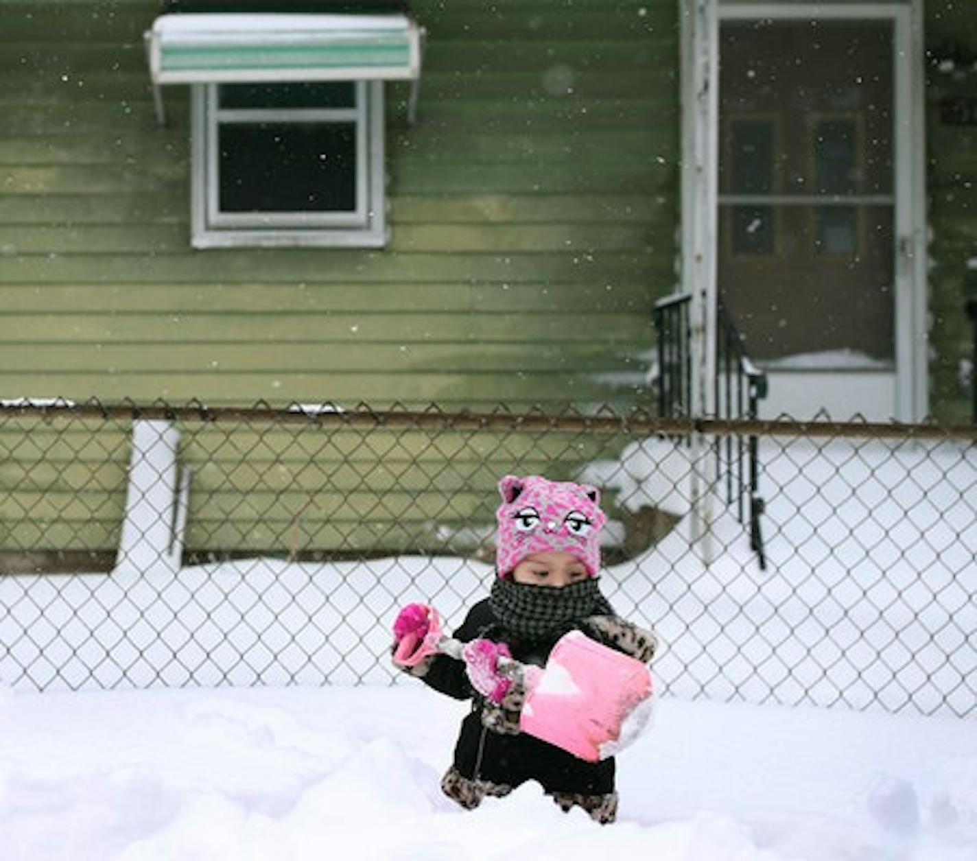 Roselyn Silvestre 2, helped shovel snow in front of her home along Penn Avenue after Saturdays blizzard Sunday April 15, 2018, in Minneapolis.