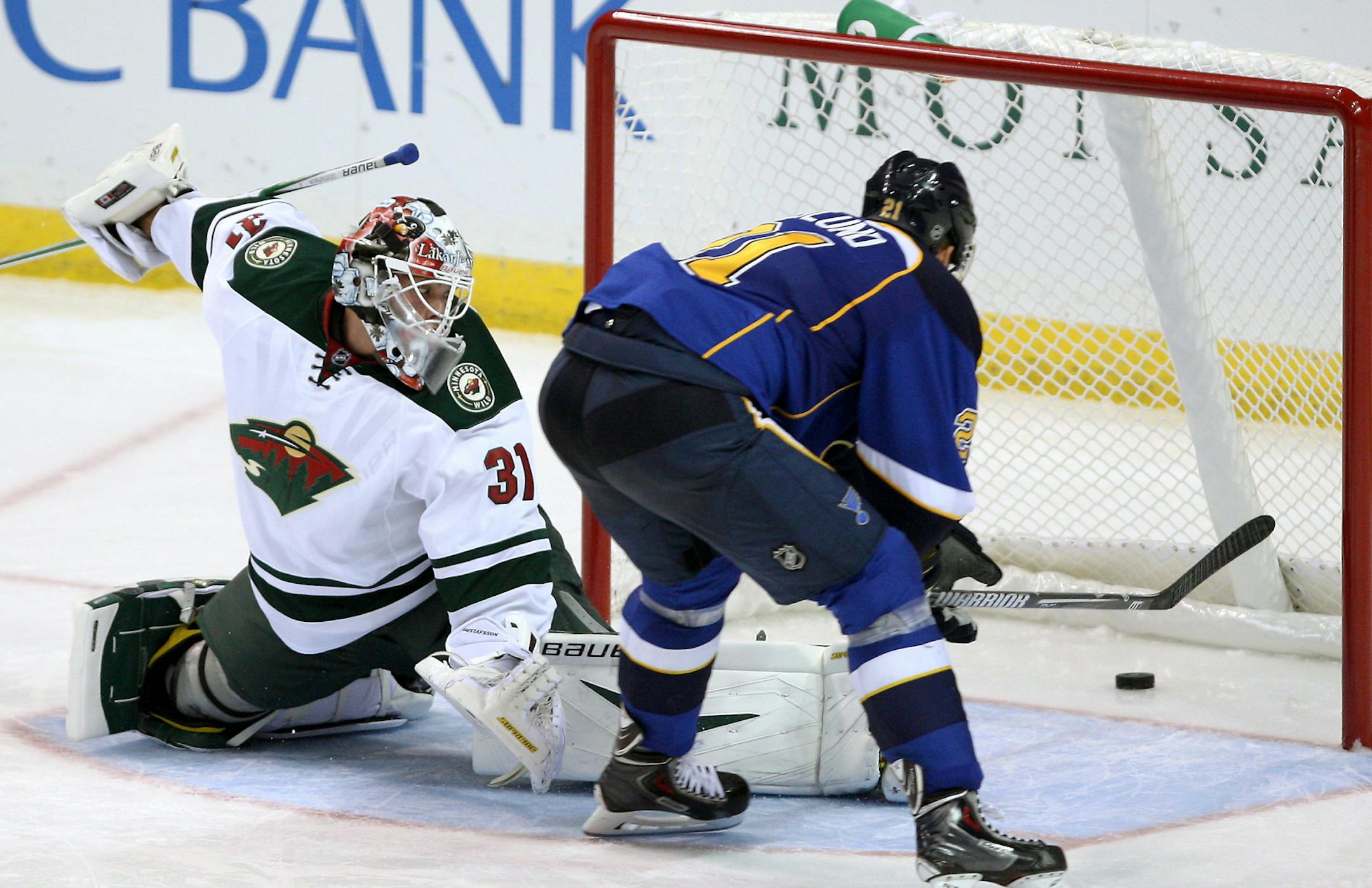 St. Louis Blues' Patrik Berglund, right, of Sweden, gets the puck past Minnesota Wild goalie Johan Gustafsson for a goal during the third period of a preseason NHL hockey game Friday, Sept. 27, 2013, in St. Louis. (AP Photo/Scott Kane)