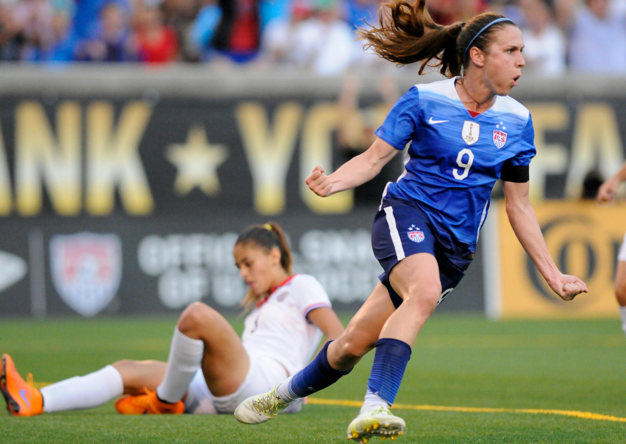 United States' Heather O'Reilley (9) celebrates scoring a goal as Costa Rica defender Fabiola Villalobos sits on the ground during an international friendly soccer match Wednesday, Aug. 19, 2015, in Chattanooga, Tenn. (Doug Strickland/Chattanooga Times Free Press via AP)