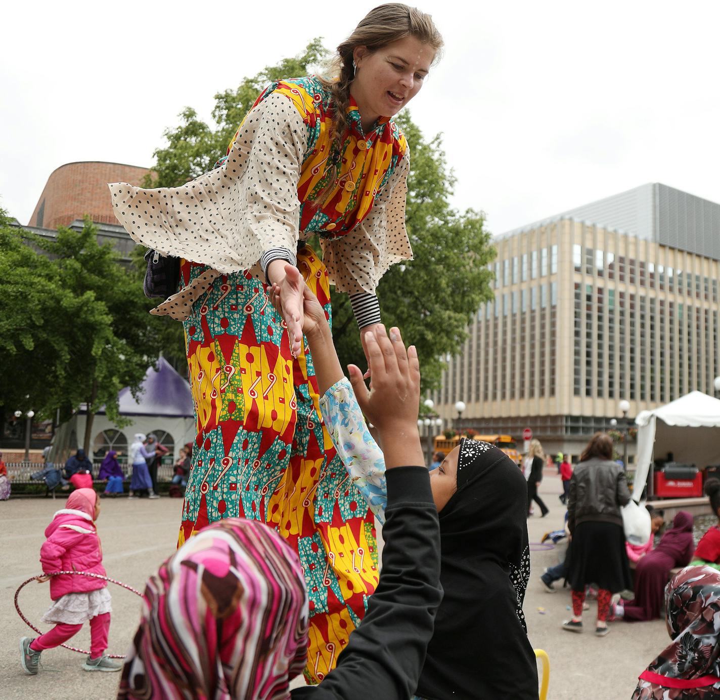 Stilt-walker Angie Courchaine with the group Chicks on Sticks got high-fives from a group of children.