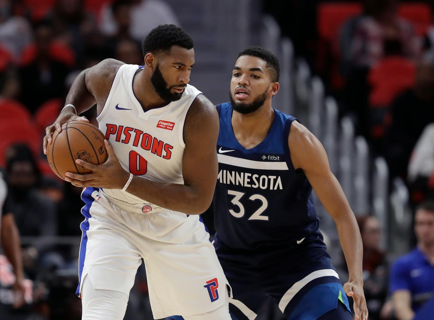 Detroit Pistons center Andre Drummond (0) is defended by Minnesota Timberwolves center Karl-Anthony Towns (32) during the second half of an NBA basketball game, Wednesday, Oct. 25,2017, in Detroit. (AP Photo/Carlos Osorio)