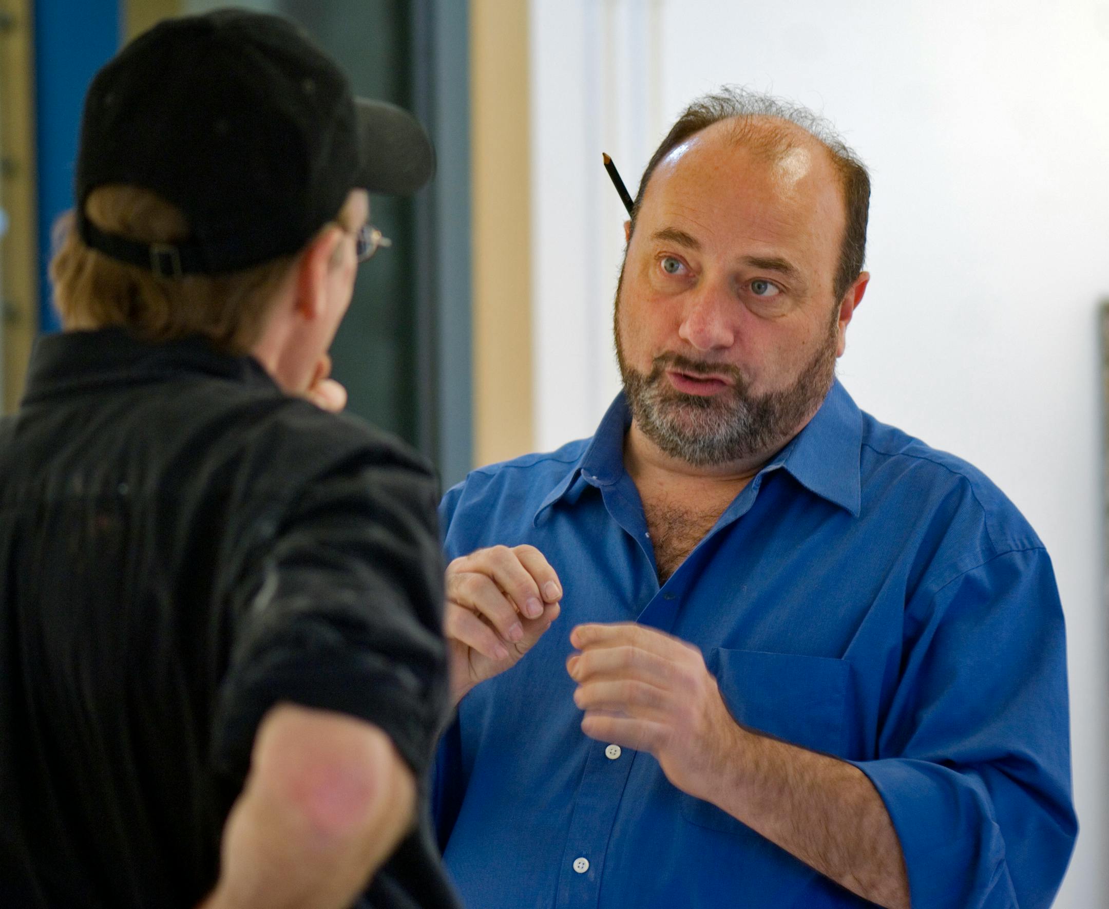 Howard Christopherson, right, owner of a framing shop and fine-art photo gallery, had a discussion with Dan Havel, who will be part of a retrospective exhibit that will open Saturday.