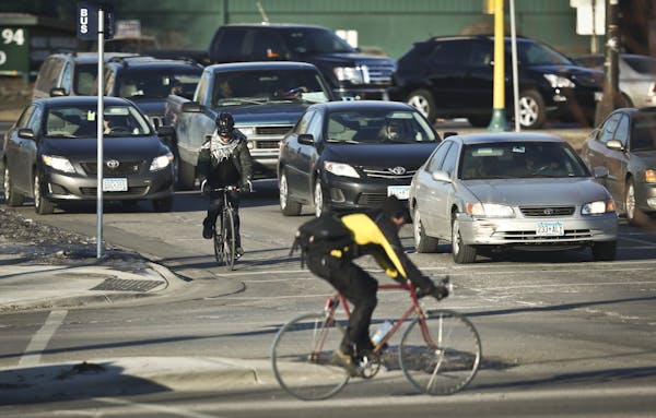 Bicyclists crossed Cedar Avenue and East Franklin Avenue in traffic on Tuesday, January 15, 2013, in Minneapolis, Minn. This intersection has had 20 b