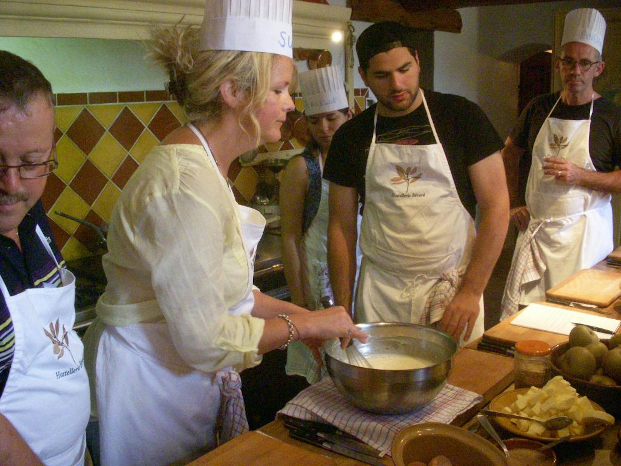 Students in the gourmet cooking class of the Hostellerie Berard in La Cadiere d'Azur, France do most of the work.