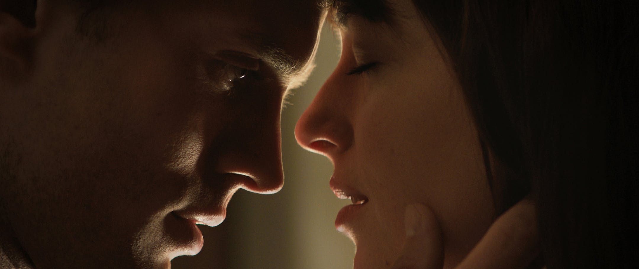 In this image released by Universal Pictures and Focus Features, Jamie Dornan, left, and Dakota Johnson appear in a scene from "Fifty Shades of Grey." The ticket-buying site Fandango said pre-sales have propelled the movie into the 15-year-old company's Top 5 for R-rated selections. Several hundred screenings have already sold out from Tupelo, Mississippi, to Chattanooga, Tennessee, the company said. (AP Photo/Universal Pictures and Focus Features)