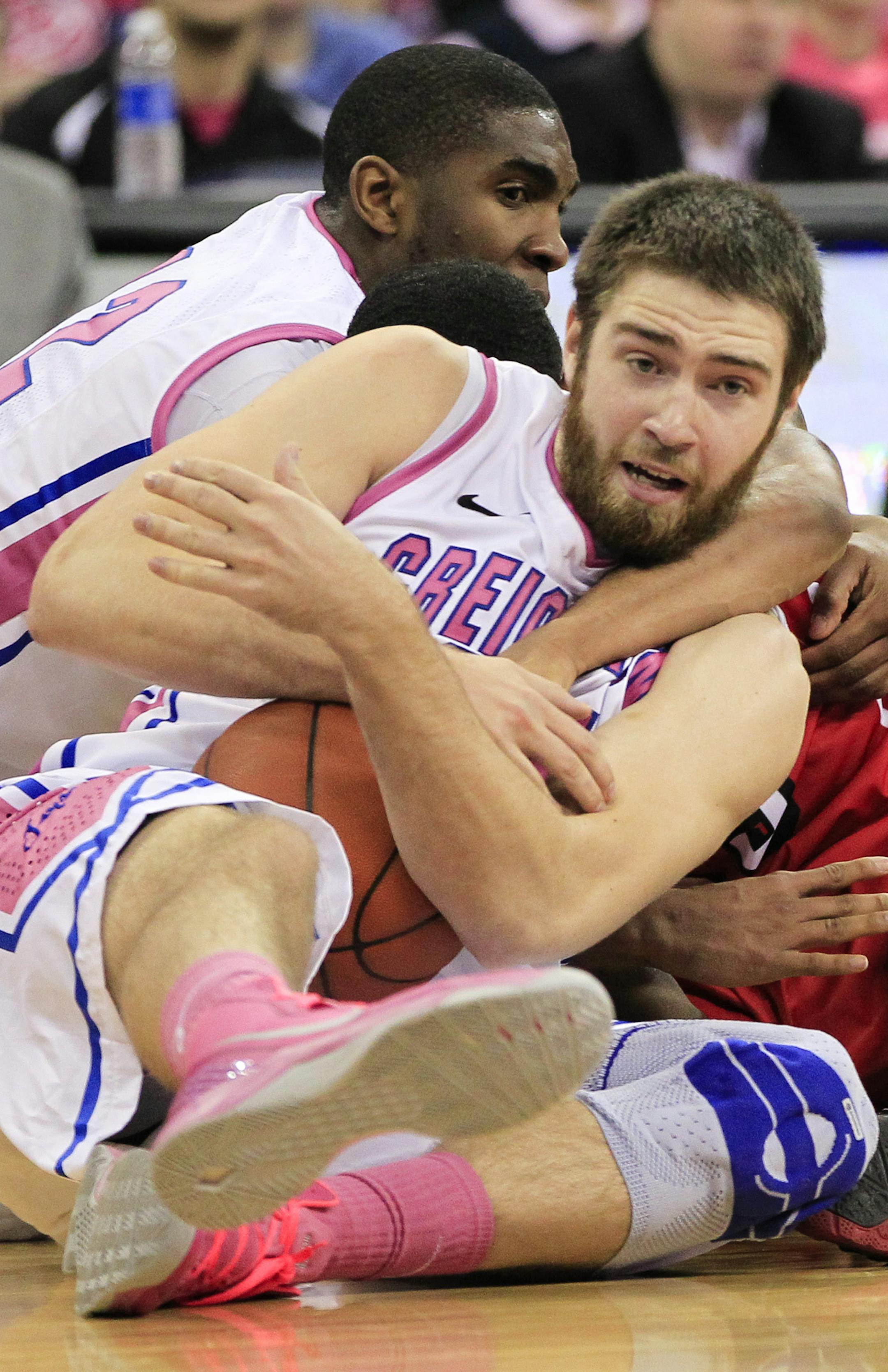 FILE - In this Feb. 2, 2013 file photo, Creighton's Ethan Wragge, front, and Jahenns Manigat, left rear, struggle for a loose ball against Bradley's Walt Lemon Jr. (obscured) in the first half of an NCAA college basketball game in Omaha, Neb. When Wragge is at his best, Creighton has been almost unbeatable. When he's struggling, so do the Bluejays. He'll be a big part of the game plan Friday against defensive-minded Cincinnati in the NCAA Midwest Regional in Philadelphia.(AP Photo/Nati Harnik, F