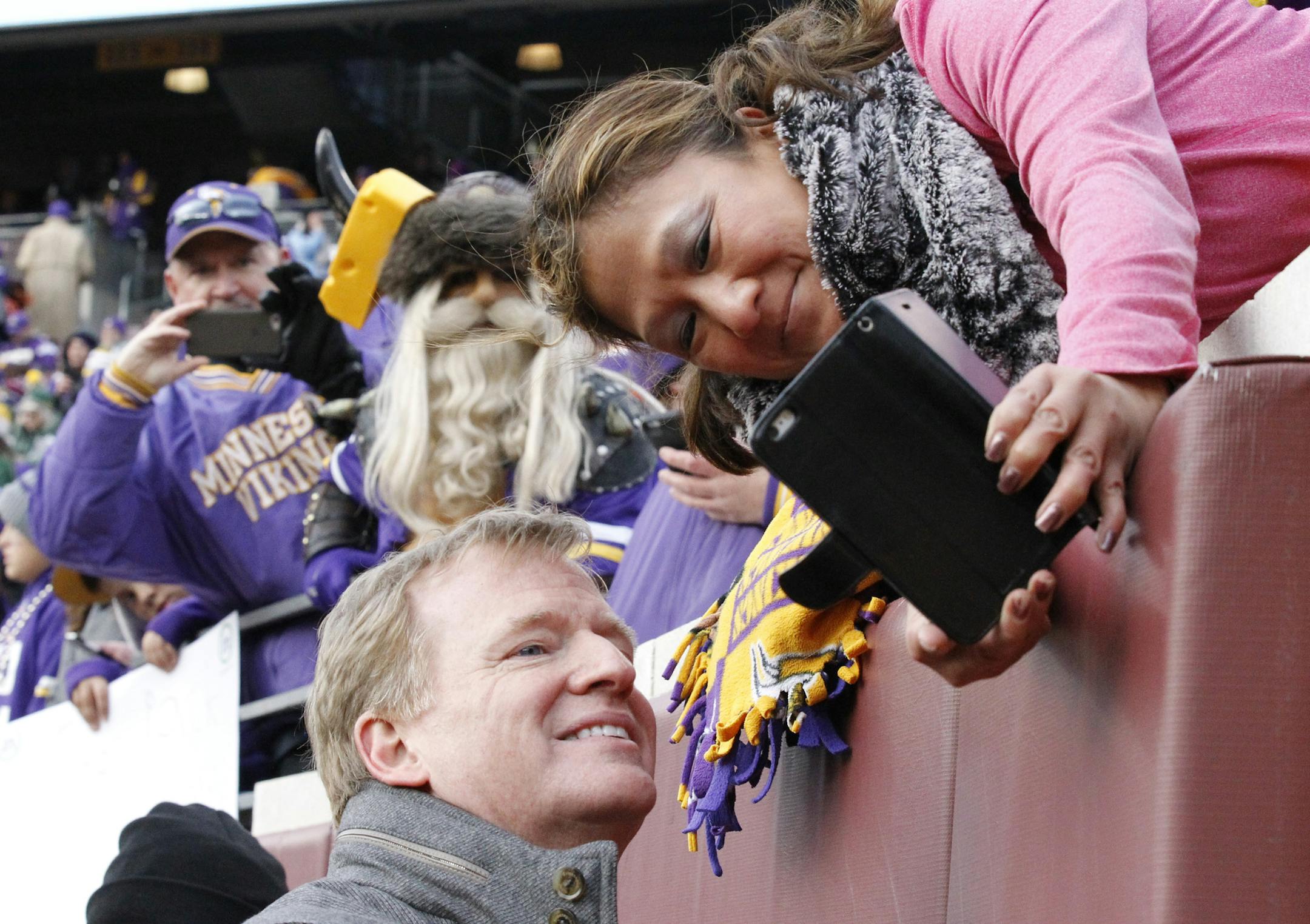 NFL commissioner Roger Goodell takes a selfie with a fan before an NFL football game between the Minnesota Vikings and the Green Bay Packers in Minneapolis, Sunday, Nov. 22, 2015. (AP Photo/Ann Heisenfelt)