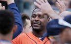 Houston Astros' Chris Carter is congratulated after scoring the go-ahead run against the Detroit Tigers during the sixth inning of a baseball game Sat