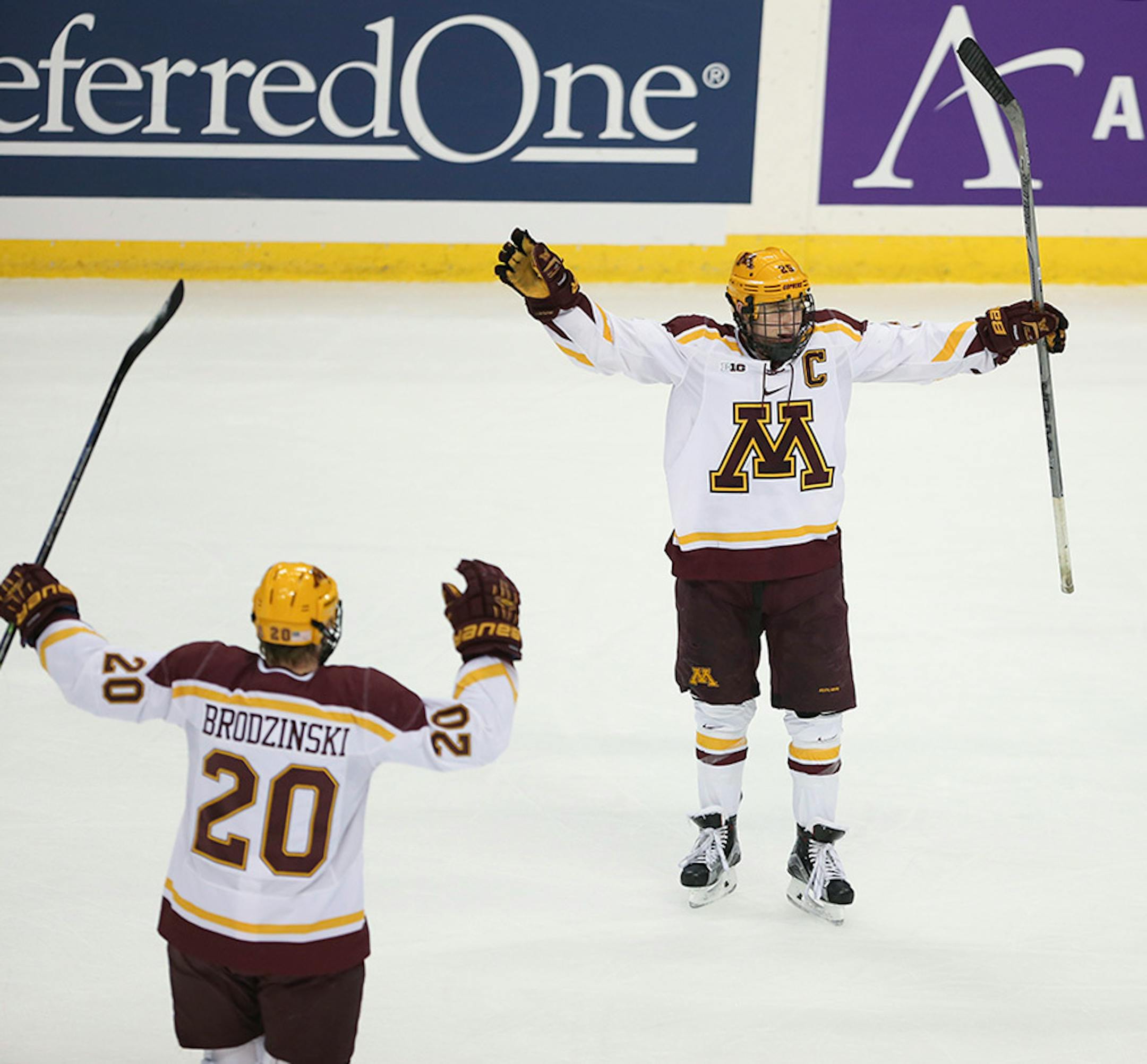 Gophers forward Justin Kloos celebrated his game-tying goal in the first period Sunday afternoon as Gophers defenseman Michael Brodzinski (20) skated to join him.