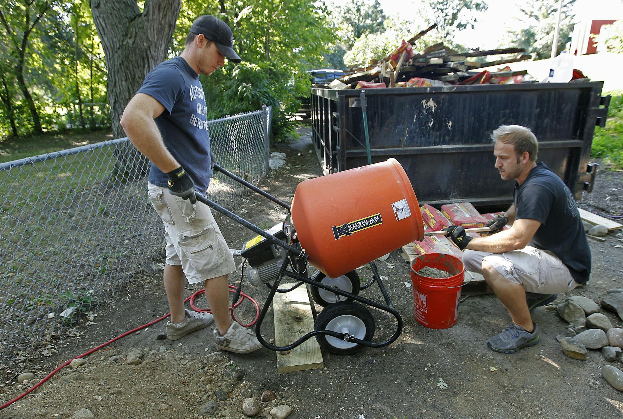Dan Wheeler, left, and Zach Weinkauf, worked on pouring concrete for posts of a deck, Thursday, August 22, 2013 in Monticello, MN. Even though the home market is rebounding in the Twin Cities and across the country, construction jobs remain stagnant. One explanation is that the recession shifted large numbers of construction workers into working for themselves.(ELIZABETH FLORES/STAR TRIBUNE) ELIZABETH FLORES • eflores@startribune.com