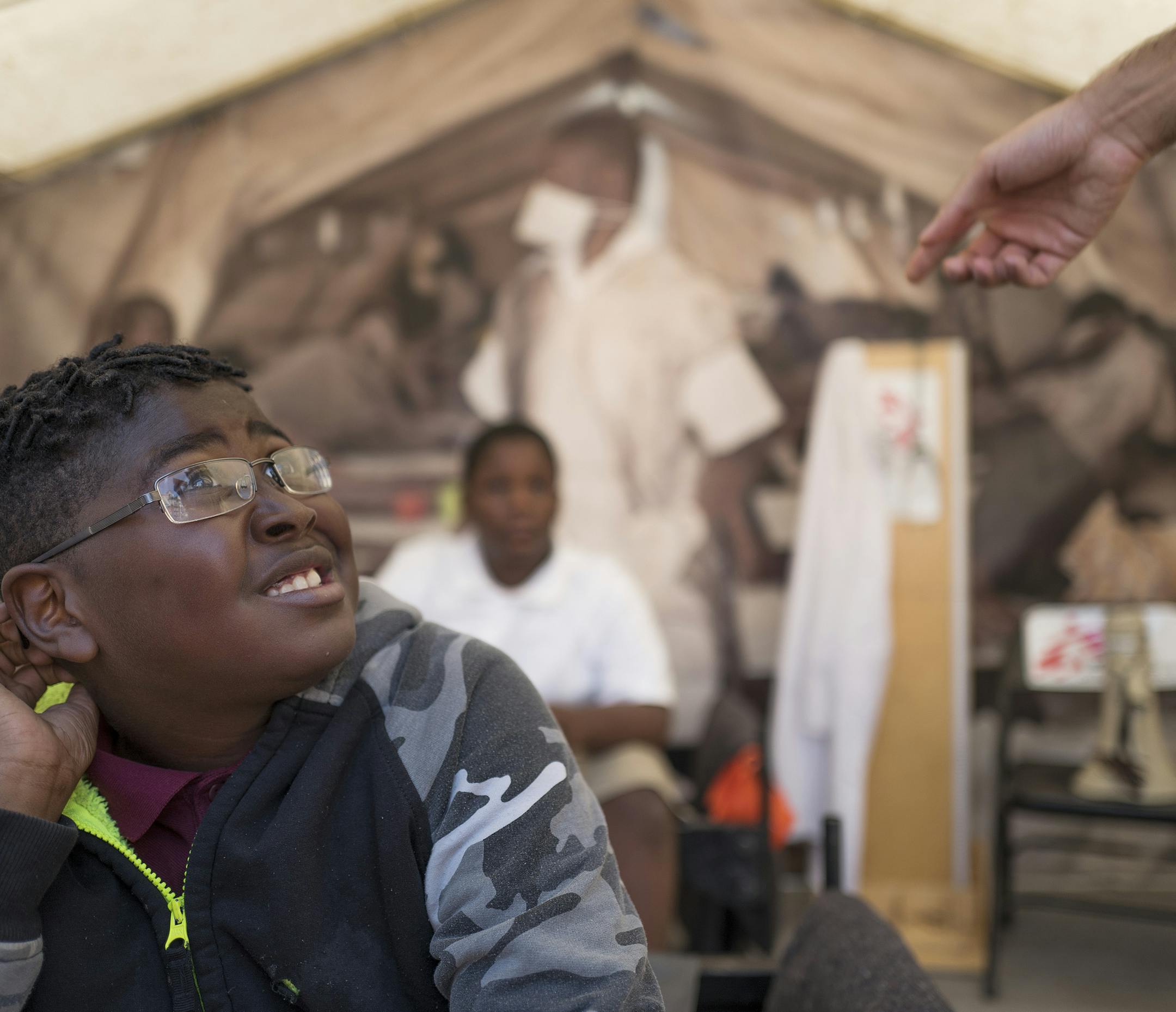 Treyvon Wilson a sixth grader at The Mastery School listened during a tour of and exhibit of a cholera treat center tent. Doctors Without Borders presents Forced From Home, a free interactive tour that takes you behind the headlines about the global refugee crisis during an exhibit at The Commons Monday September 10, 2018 in Minneapolis, MN. ] JERRY HOLT ï jerry.holt@startribune.com.