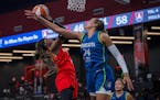 Atlanta Dream guard Rhyne Howard goes for a layup while guarded by Minnesota Lynx's Napheesa Collier (24) during a WNBA basketball game Tuesday, July 