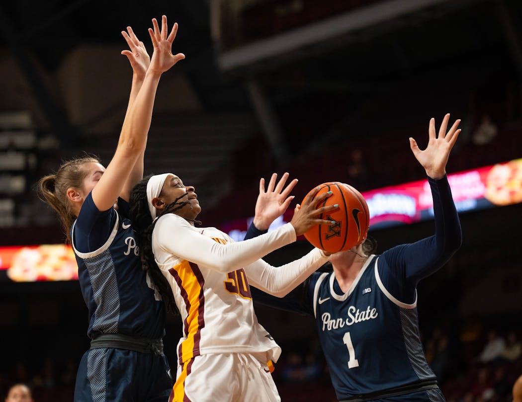Gophers guard Janay Sanders attempted a shot between Penn State guard Shay Ciezki and forward Ali Brigham (1) in the first half Wednesday.
