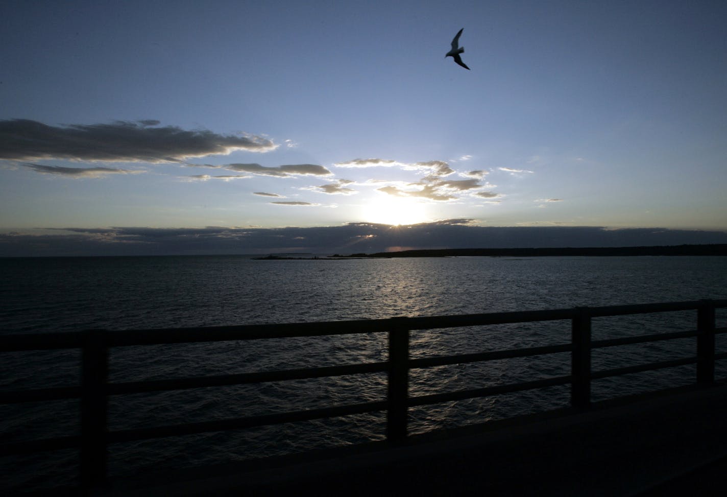 FILE - In a June 30, 2005 file photo, Michigan's Upper Peninsula and Lake Michigan is seen from the Mackinac Bridge in Mackinaw City, Mich. President Donald Trump wants to eliminate federal support of a program that addresses the Great Lakes' most pressing environmental threats. Trump's 2018 budget released Thursday, March 16, 2017, would remove all funding for the Great Lakes Restoration Initiative, which has received strong support from members of Congress in both parties since President Barac