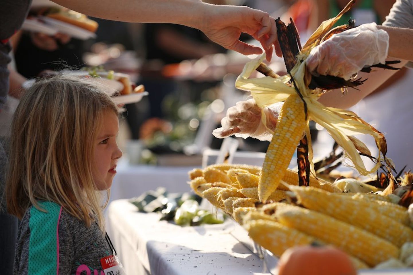 Meme Hoes, 4, of Minneapolis waited her turn for an ear of corn at the Farm to School community barbecue at the Minneapolis Public Schools Culinary and Wellness Services building in 2017.