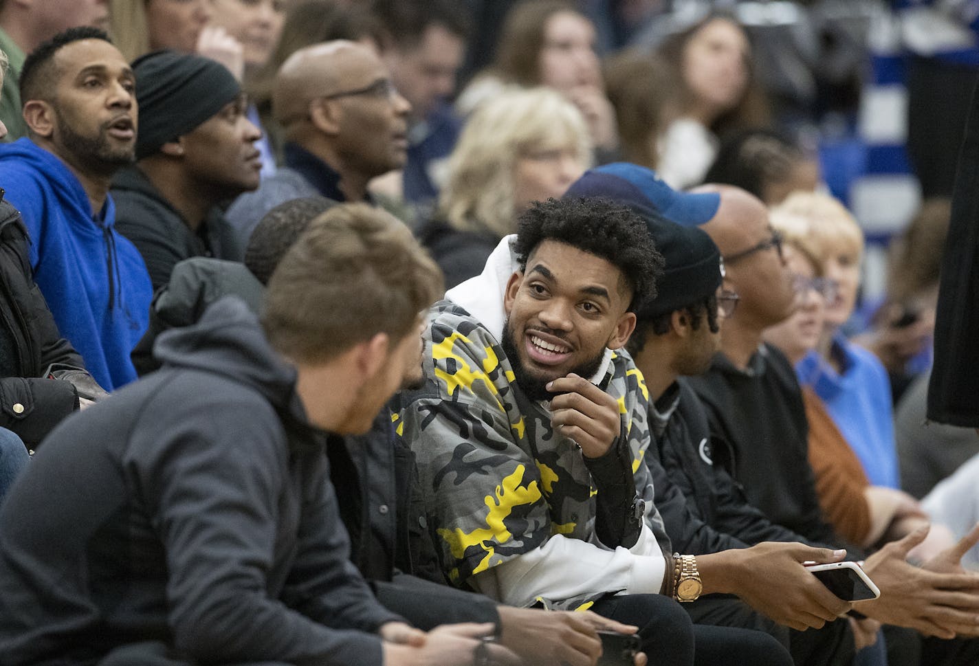 Karl-Anthony Towns chatted up fans, and later posed for selfies with them, during his visit to watch Paige Bueckers play.