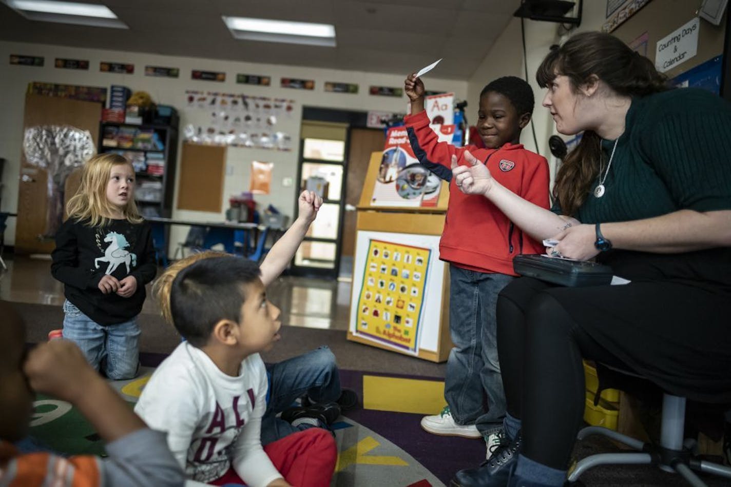 Kindergarten teacher Courtney Cline read from "Giraffes Can't Dance" by Giles Andreae. Student Davon, 6, likes to get involved. The Minneapolis School District declined to provide us with students' last names.